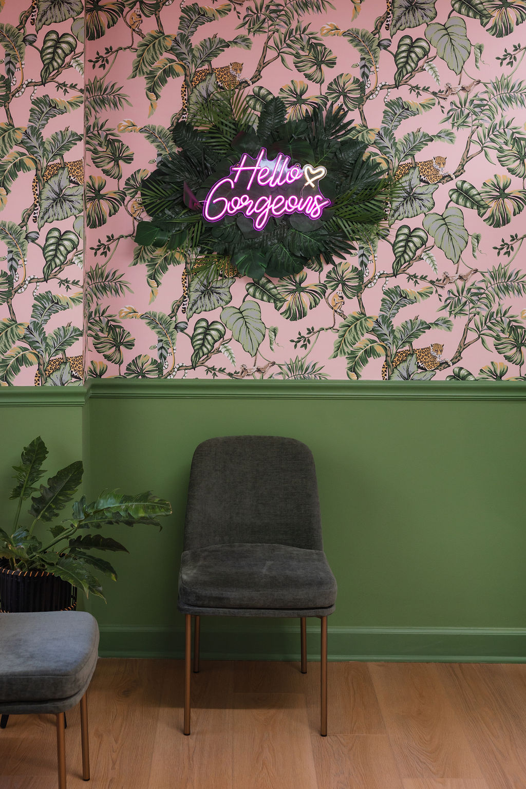 The Hello Gorgeous neon sign above the lounge seating at Fairfax Beauty Lounge